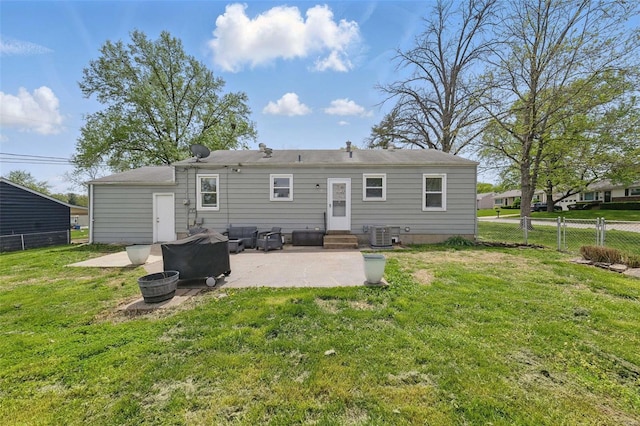 rear view of house with central air condition unit, a patio area, entry steps, a fire pit, and fence