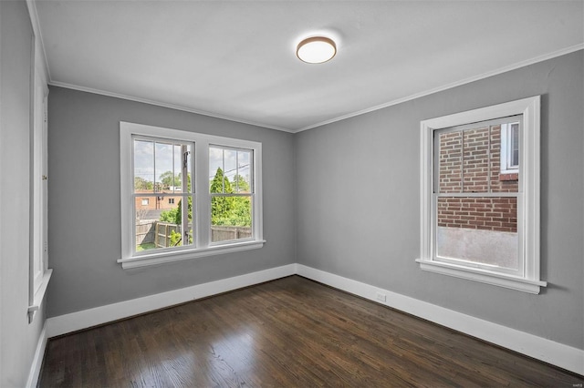 unfurnished room featuring crown molding, baseboards, and dark wood-type flooring