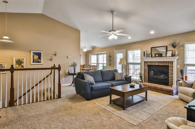 living area with vaulted ceiling, a wealth of natural light, and carpet flooring