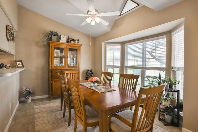 dining area featuring plenty of natural light, light carpet, baseboards, and ceiling fan