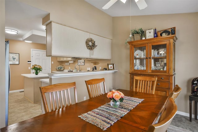 dining area with baseboards and ceiling fan