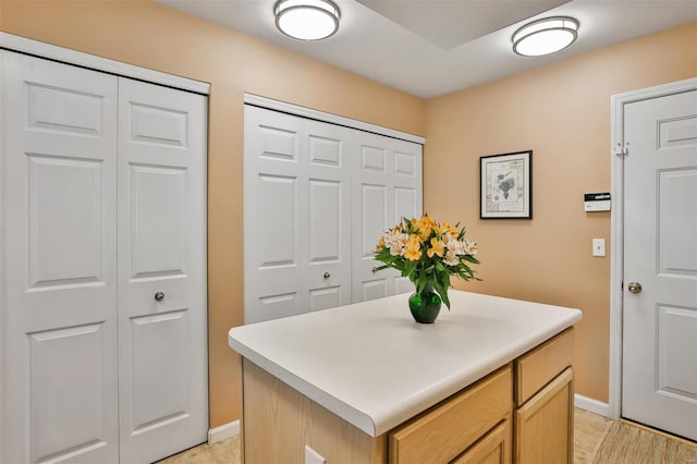 interior space featuring baseboards and light tile patterned floors