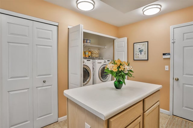 laundry room with baseboards, washer and dryer, and laundry area
