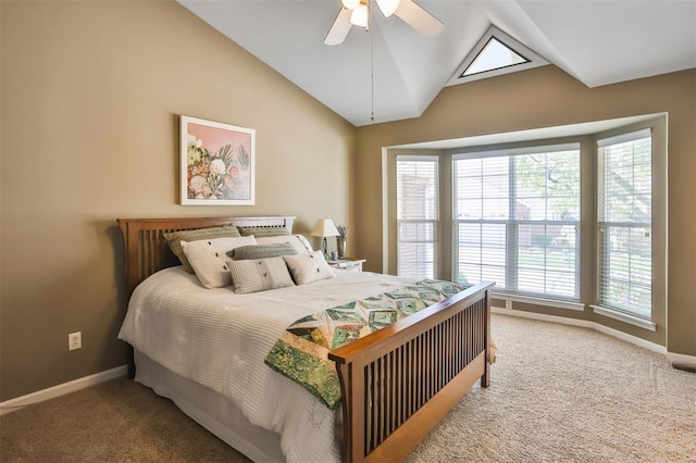 carpeted bedroom featuring lofted ceiling, baseboards, and ceiling fan
