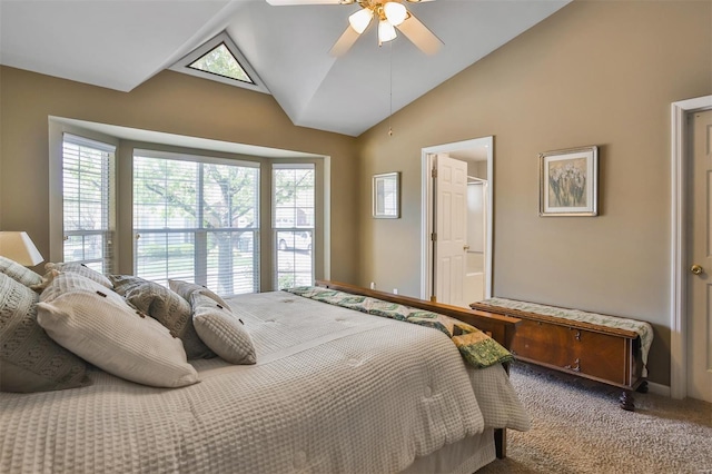 carpeted bedroom with a ceiling fan, baseboards, high vaulted ceiling, and ensuite bathroom