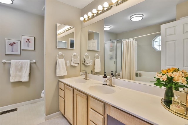 bathroom featuring a shower stall, toilet, baseboards, and a sink