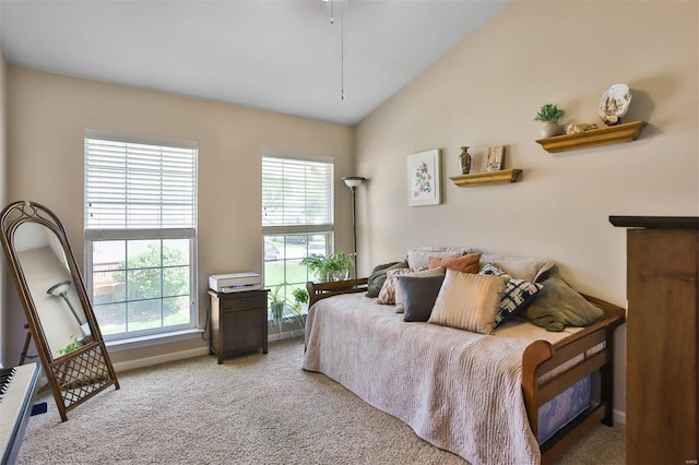 bedroom featuring light colored carpet, vaulted ceiling, multiple windows, and baseboards