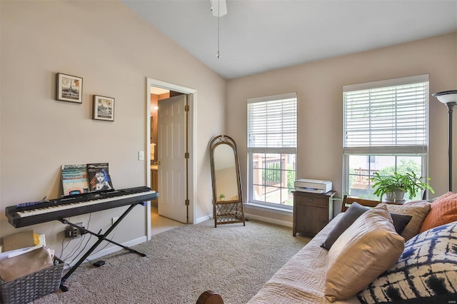 interior space featuring ceiling fan, baseboards, vaulted ceiling, and light carpet