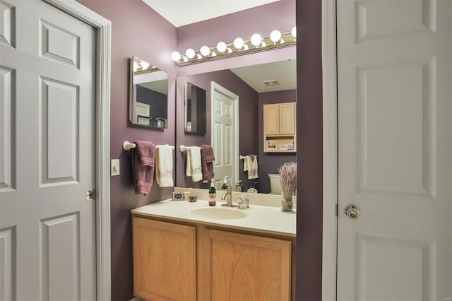 bathroom with vanity and visible vents