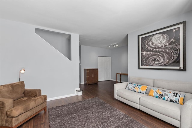 living area featuring baseboards and wood finished floors