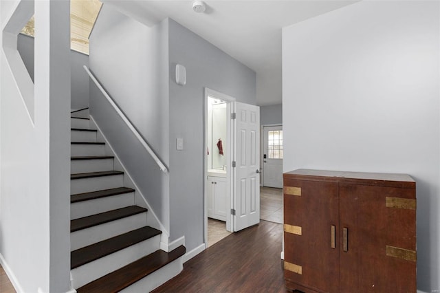stairs featuring baseboards and wood finished floors