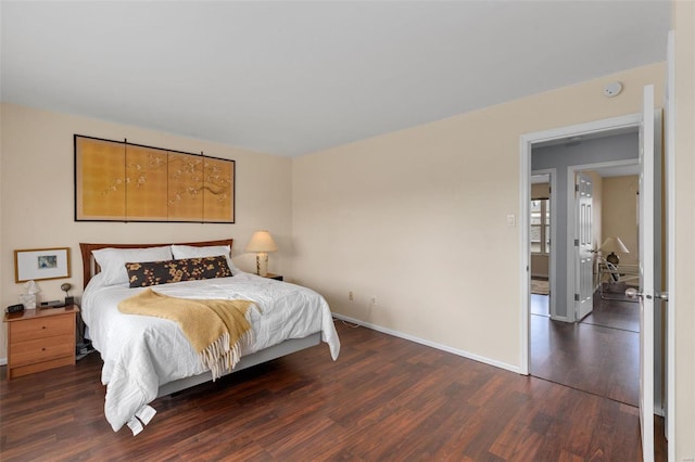bedroom with baseboards and wood finished floors