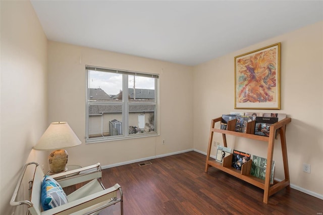 sitting room featuring baseboards, visible vents, and wood finished floors