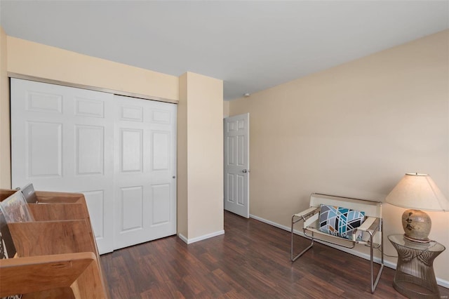 living area featuring baseboards and wood finished floors