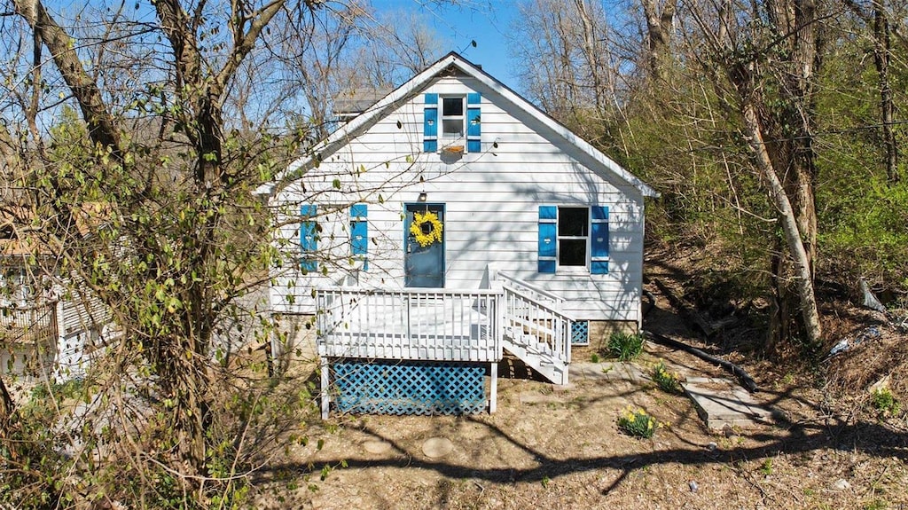 back of property featuring a wooden deck