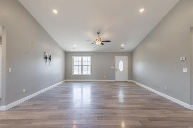 interior space with baseboards, wood finished floors, recessed lighting, and a ceiling fan