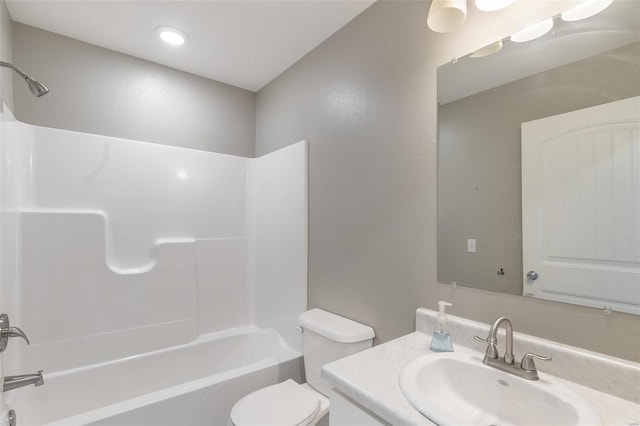 full bathroom with toilet, vanity, and shower / washtub combination