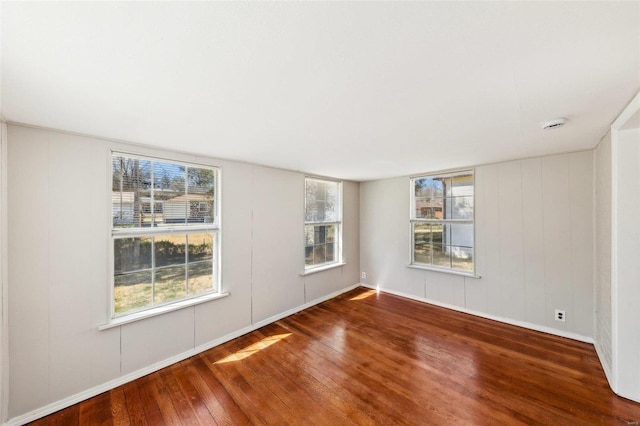 unfurnished room with hardwood / wood-style floors