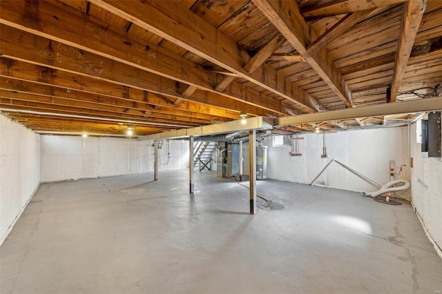 below grade area featuring heating unit, water heater, and electric panel