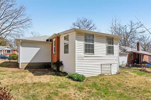 view of side of home with a lawn