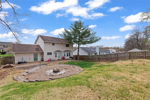 back of property featuring a fenced backyard, an outdoor fire pit, a patio, and a yard