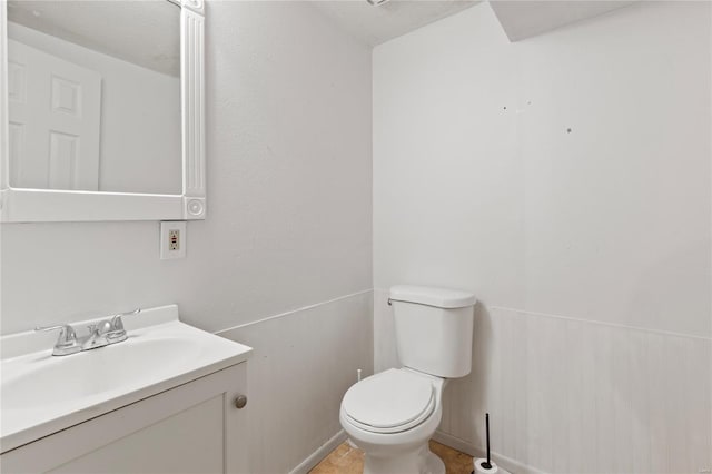 half bath featuring toilet and vanity