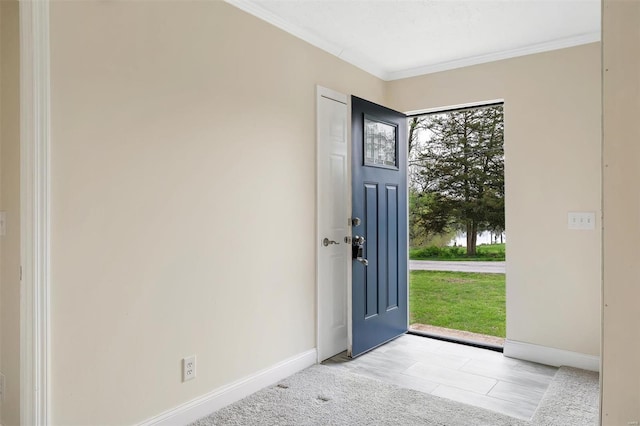 entrance foyer featuring crown molding, baseboards, and a healthy amount of sunlight