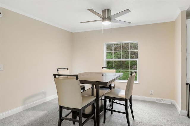 dining area with ceiling fan, baseboards, and carpet flooring