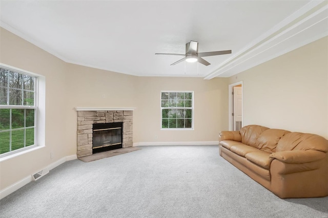 living room with carpet, a ceiling fan, visible vents, and plenty of natural light