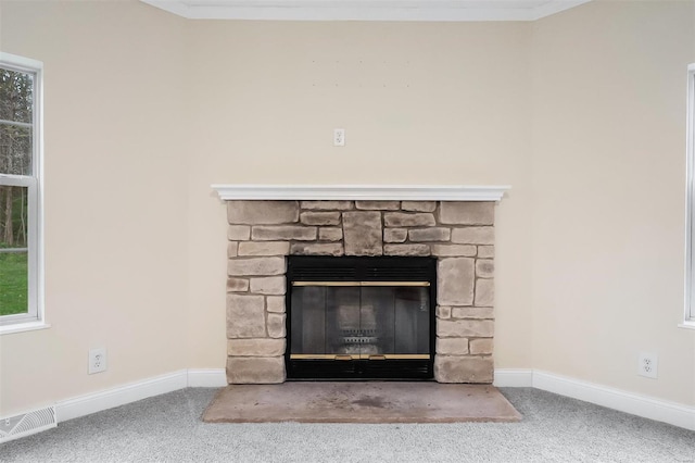 details with a fireplace, baseboards, visible vents, and carpet