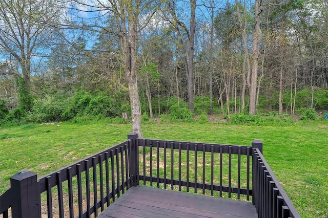 wooden terrace featuring a lawn