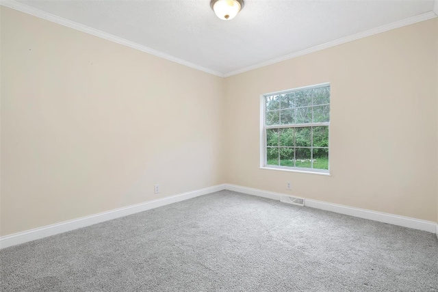 carpeted empty room featuring visible vents, crown molding, and baseboards