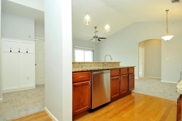 kitchen with arched walkways, a sink, vaulted ceiling, ceiling fan, and dishwasher