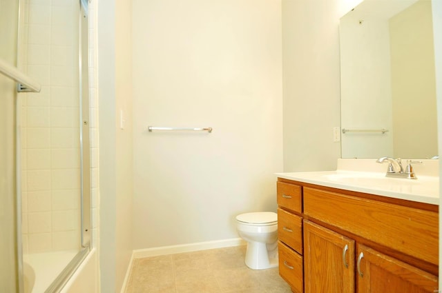 full bath with tile patterned floors, vanity, baseboards, toilet, and shower / bath combination with glass door