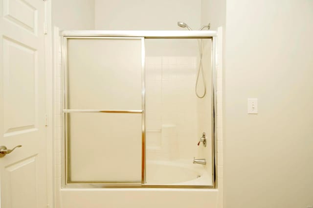 full bathroom featuring bath / shower combo with glass door