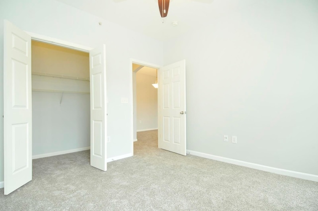 unfurnished bedroom with carpet floors, a closet, a ceiling fan, and baseboards