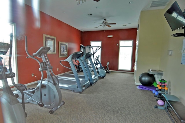 gym featuring baseboards, a ceiling fan, visible vents, and carpet