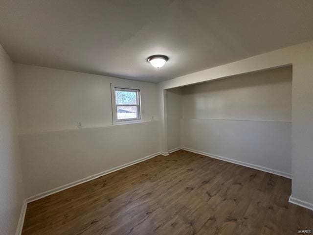 empty room featuring baseboards and wood finished floors