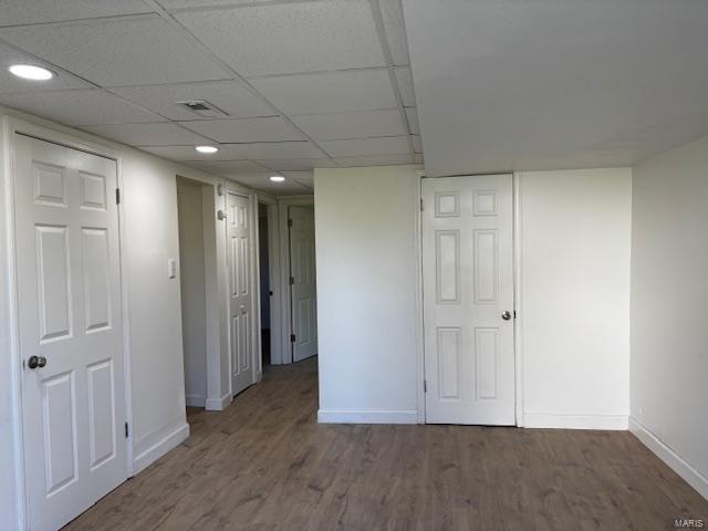 spare room with recessed lighting, wood finished floors, and baseboards