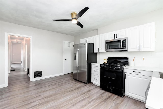 kitchen featuring light wood finished floors, ceiling fan, light countertops, appliances with stainless steel finishes, and white cabinetry
