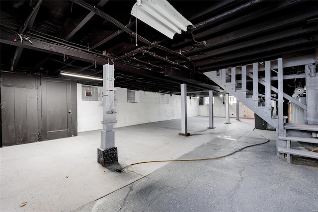 unfinished below grade area featuring stairs