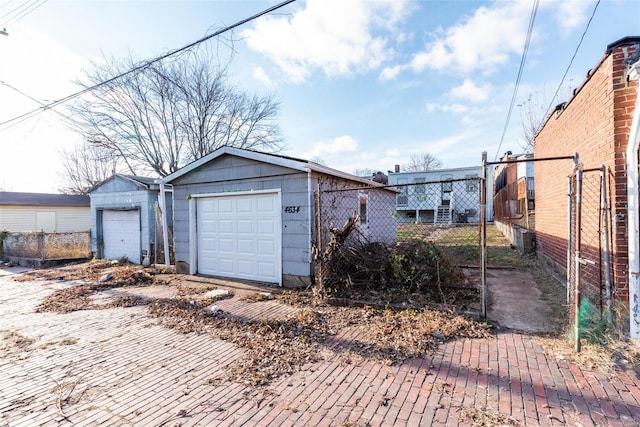 detached garage featuring fence