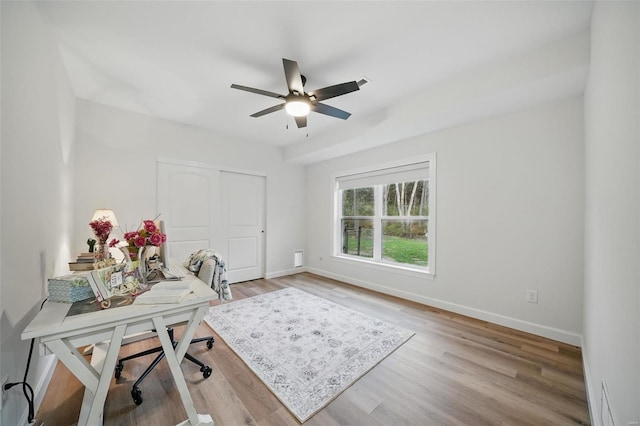 home office featuring light wood-type flooring, baseboards, and ceiling fan