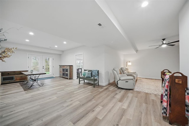 living room with visible vents, baseboards, recessed lighting, light wood-style floors, and french doors