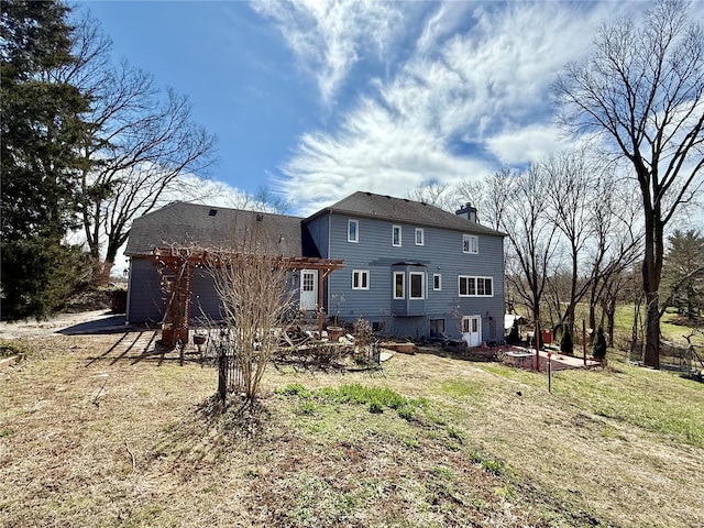 back of property featuring a chimney