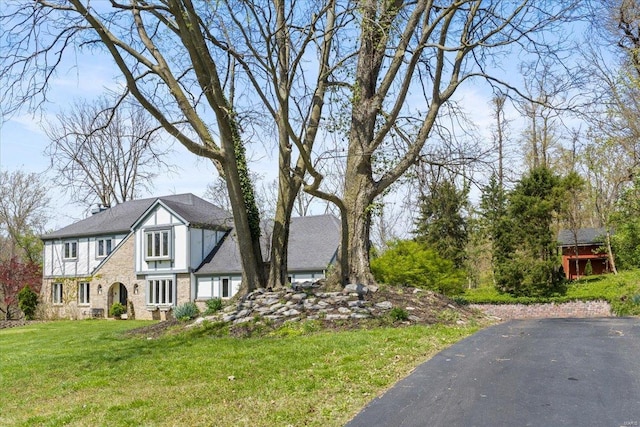 tudor house with a front yard