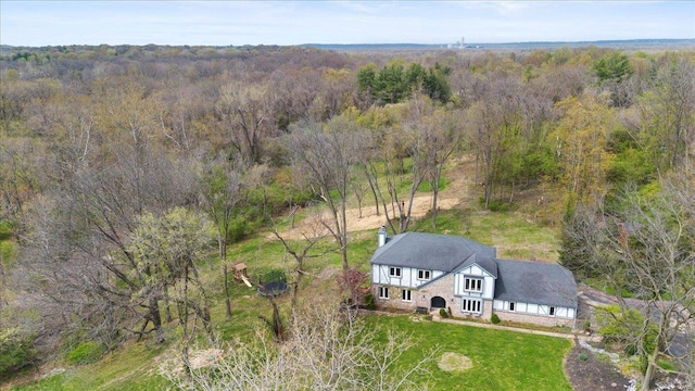 drone / aerial view featuring a forest view