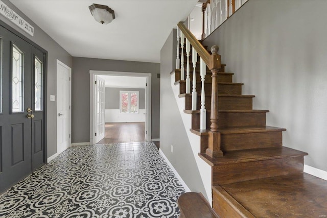 foyer with stairway and baseboards
