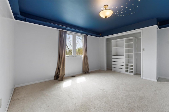 unfurnished bedroom with visible vents, baseboards, and carpet flooring