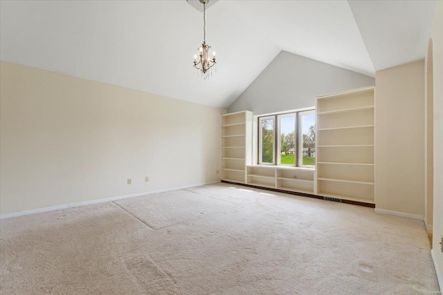 carpeted spare room featuring high vaulted ceiling, baseboards, and an inviting chandelier